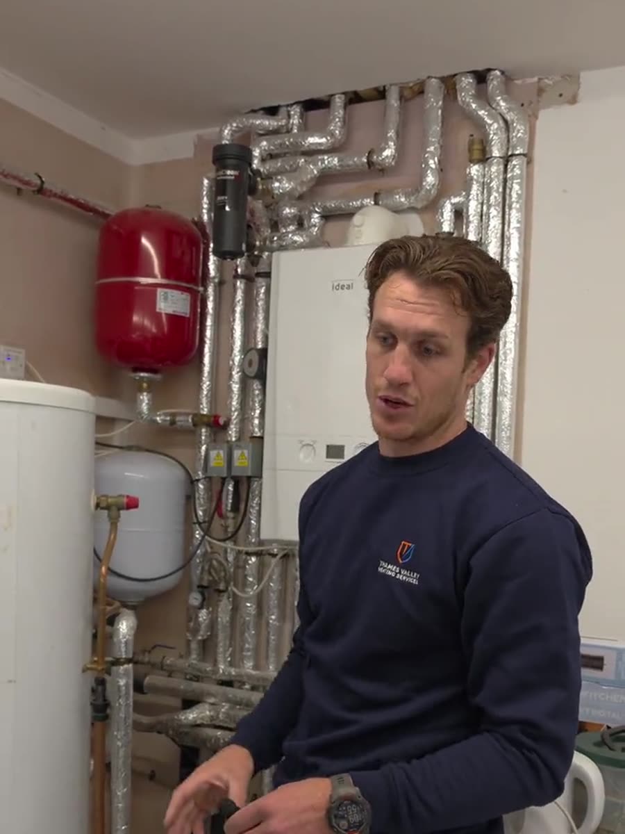 A wall hung boiler, unvented cylinder and red expansion vessel with insulated pipework running between them