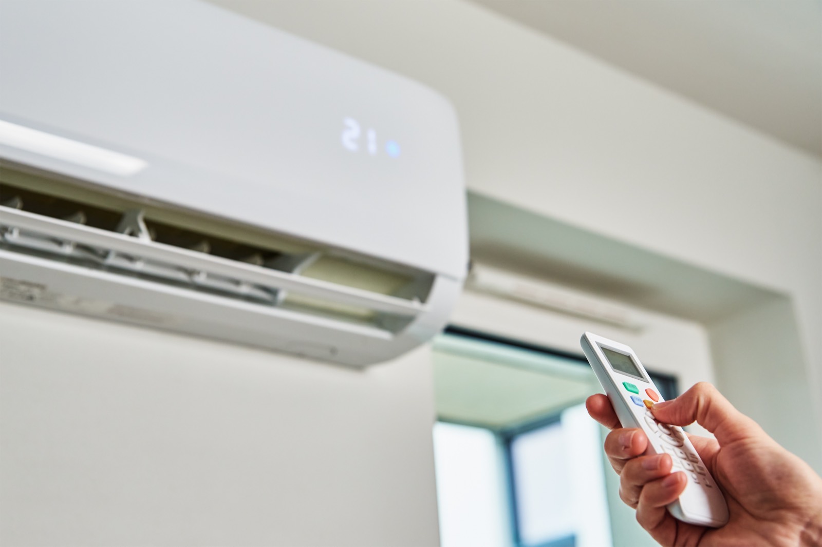 Setting the temperature on a wall mounted air conditioning unit installed by Thames Valley Heating & Cooling across Berkshire, Surrey and Hampshire